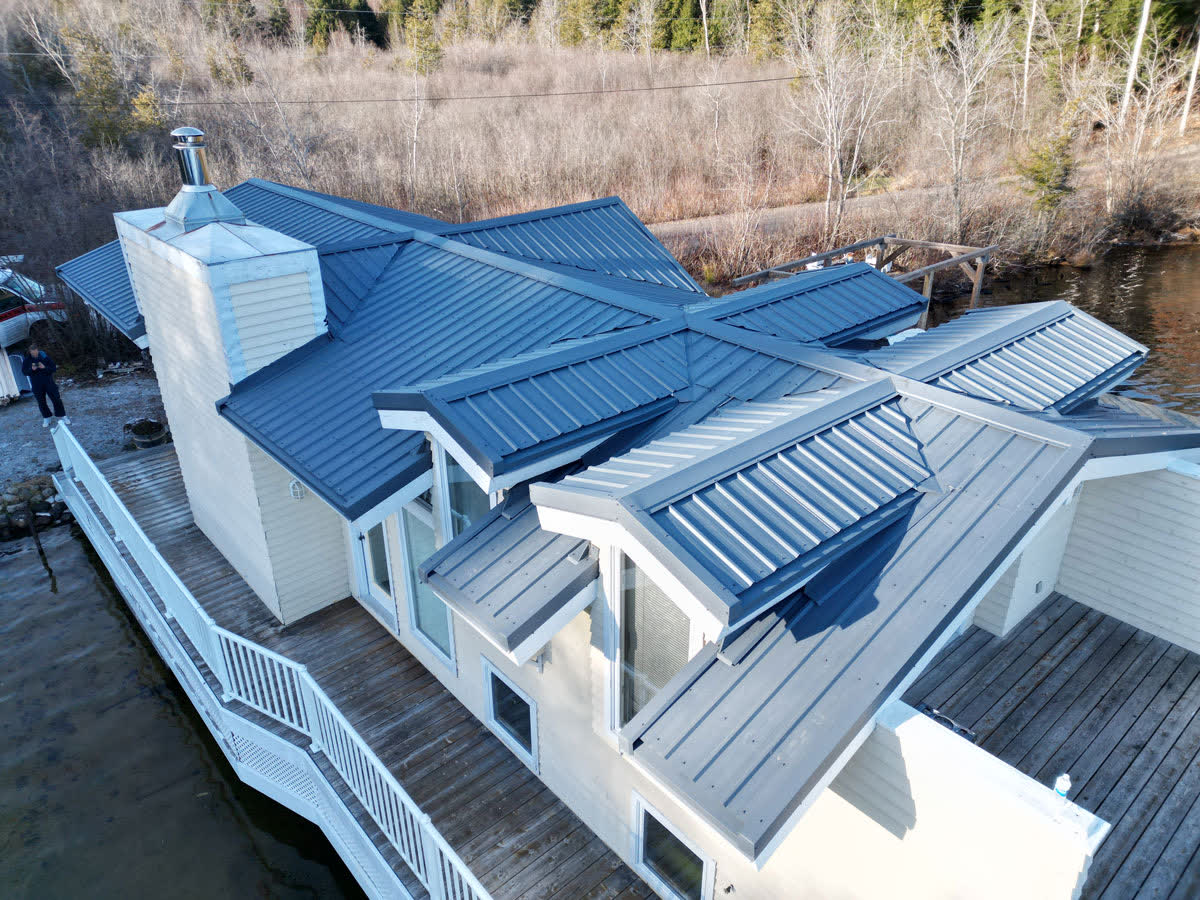 Waterfront home with a blue steel roof
